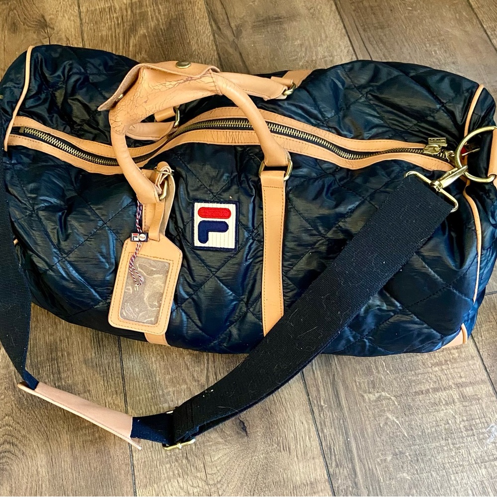 Fila Black and Tan Duffel Bag with Adjustable Strap. Normal wear.